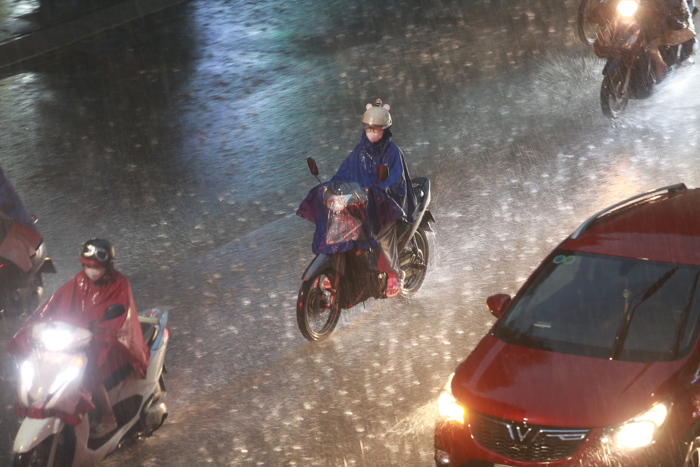 Người dân vội vã về nhà dưới cơn mưa trắng trời.