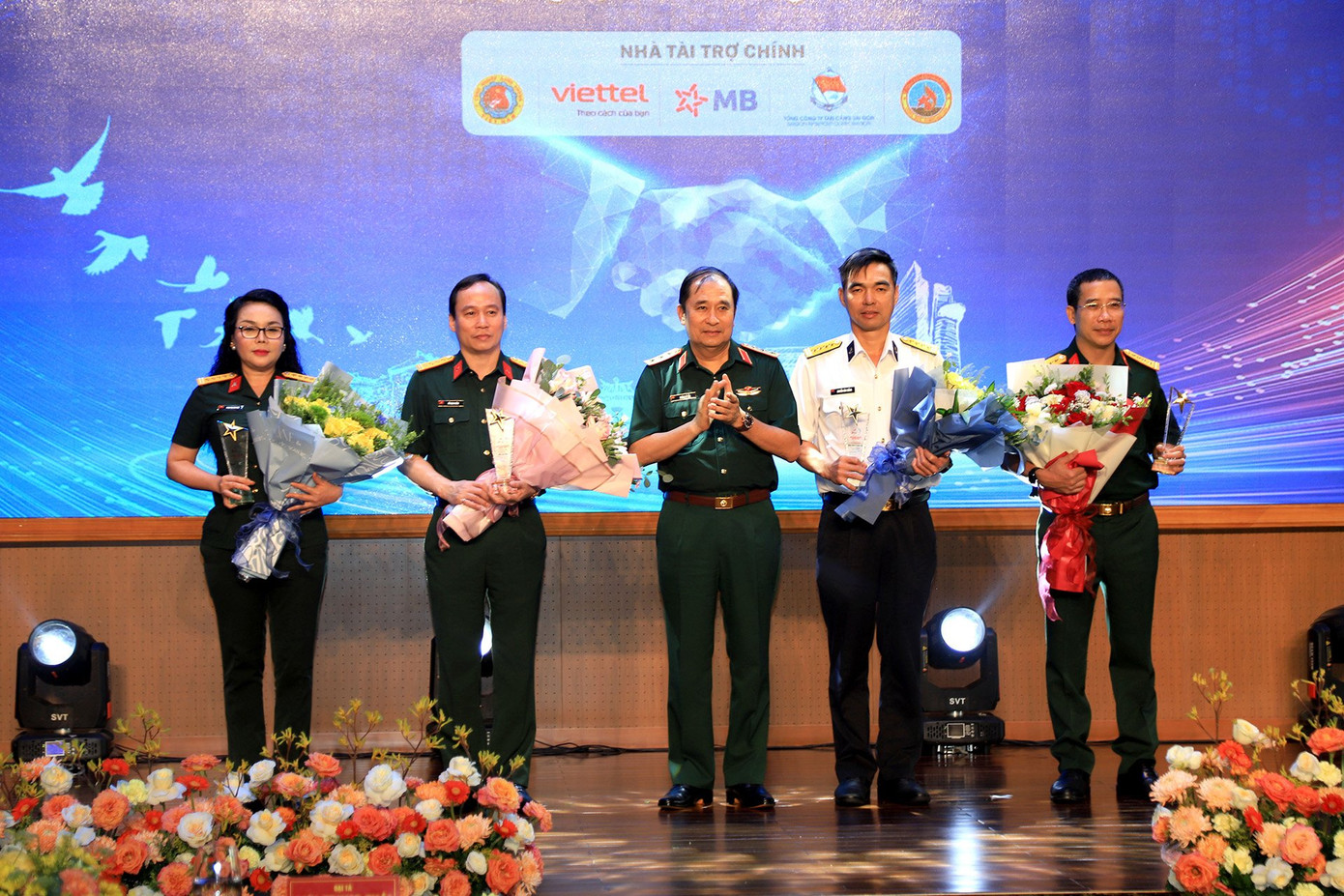 Lãnh đạo Bộ Tổng tham mưu QĐND Việt Nam trao hoa và biểu trưng tặng đại diện các đơn vị tài trợ triển lãm.