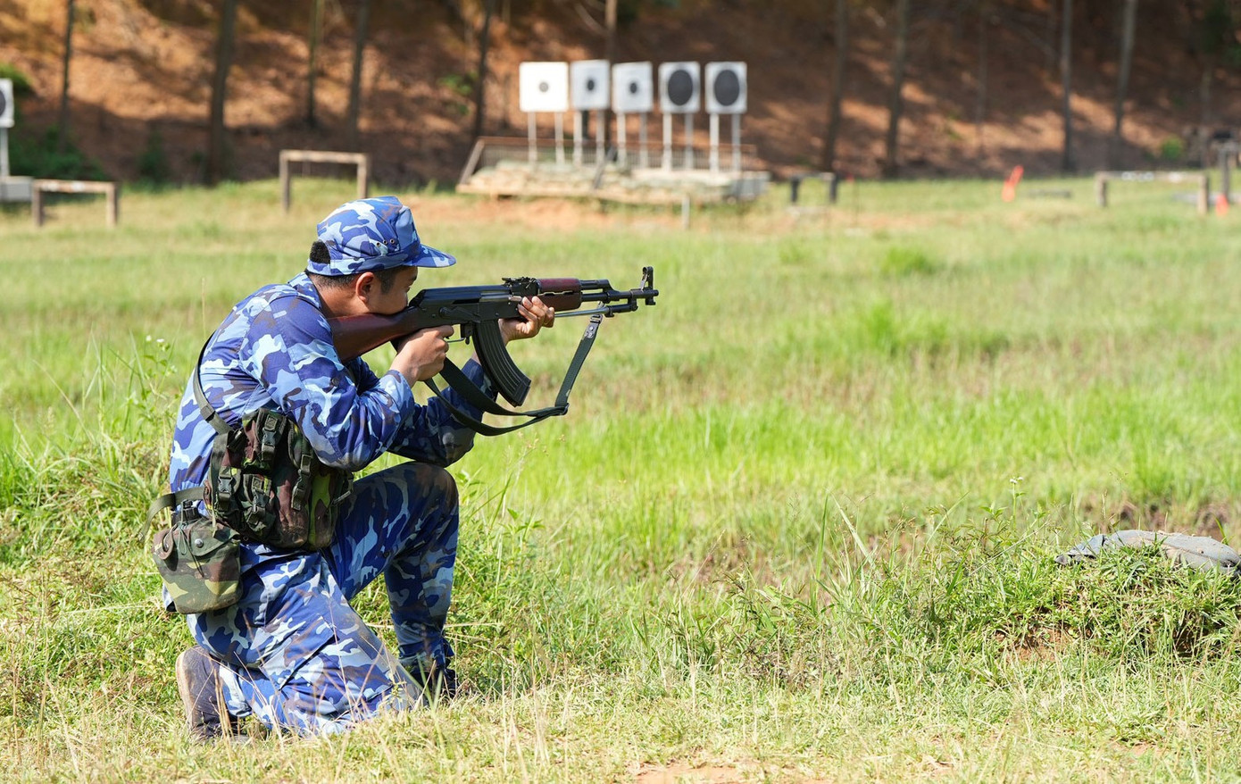 Tuyển thủ nam thực hiện bài bắn mục tiêu ẩn, hiện vận động ban ngày.
