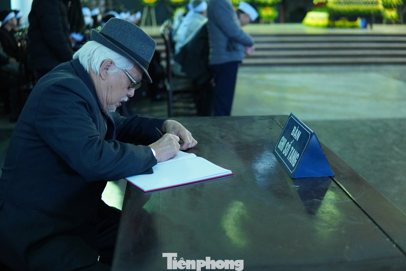 NSƯT Đức Trung đến tiễn biệt và viết những lời cuối, từ biệt NSND Trần Tiến về nơi an nghỉ cuối cùng. Ảnh: TRỌNG QUÂN.