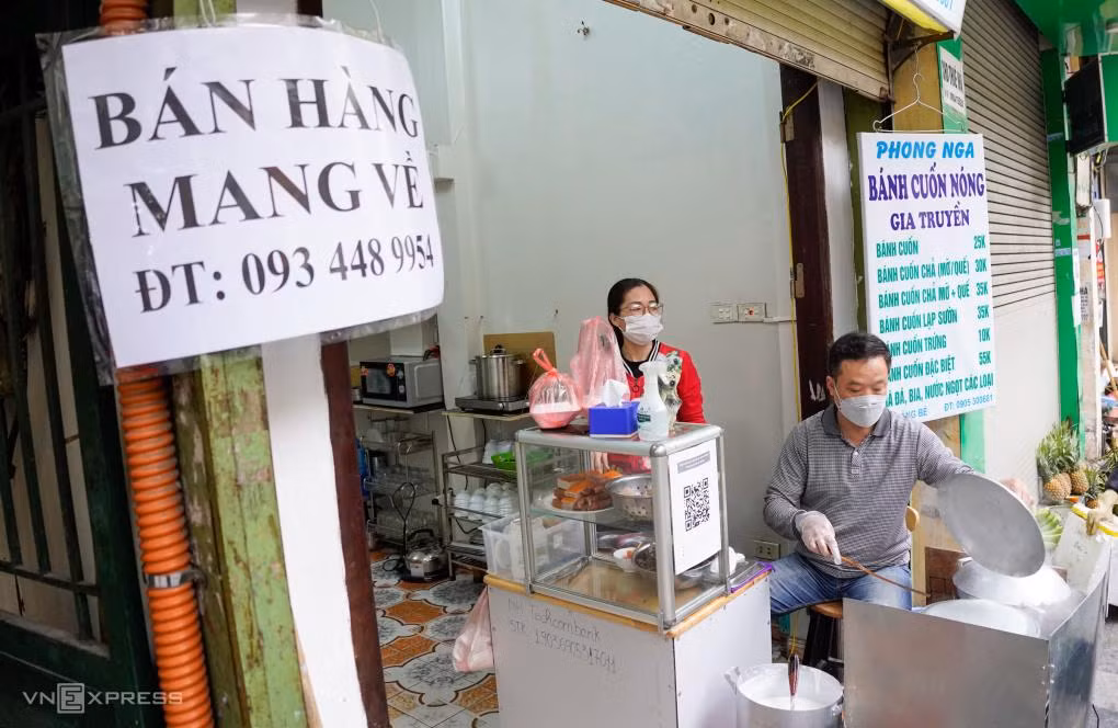 Một cửa hàng bánh cuốn trên phố Hàng Bè, quận Hoàn Kiếm treo biển "bán mang về" từ ngày 26/12. Chủ cửa hàng nói lượng khách giảm nhiều so với trước. Ảnh: Giang Huy