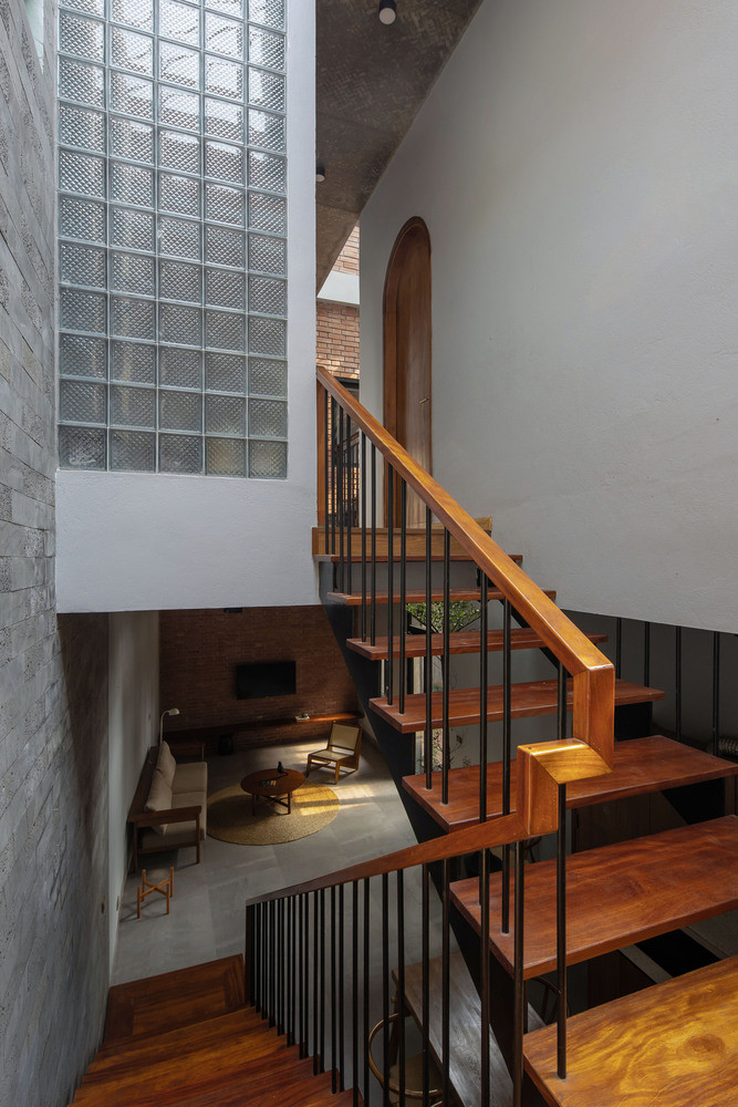 Không gian bên trong được thiết kế theo phong cách tối giản với những không gian ở tầng một là không gian chung, không có tường ngăn cách phòng khách, phòng ăn và phòng bếp. Tầng hai có hai phòng ngủ, một cầu thang sắt nối với mái thông qua giếng trời ở giữa nhà. Không gian bên trong được thiết kế theo phong cách tối giản với những không gian ở tầng một là không gian chung, không có tường ngăn cách phòng khách, phòng ăn và phòng bếp. Tầng hai có hai phòng ngủ, một cầu thang sắt nối với mái thông qua giếng trời ở giữa nhà.