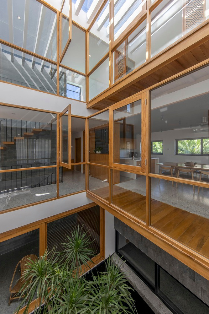 Ngôi nhà có kết cấu 3 tầng, tầng 1 làm văn phòng, tầng 2 và 3 dành cho không gian sinh hoạt của gia đình. Để không gian sống trở nên nhẹ nhàng và thân mật hơn, kiến trúc sư sử dụng những vật liệu tối giản và đồng nhất, tương phản với những bức tường trắng là đồ nội thất bằng gỗ tự nhiên.