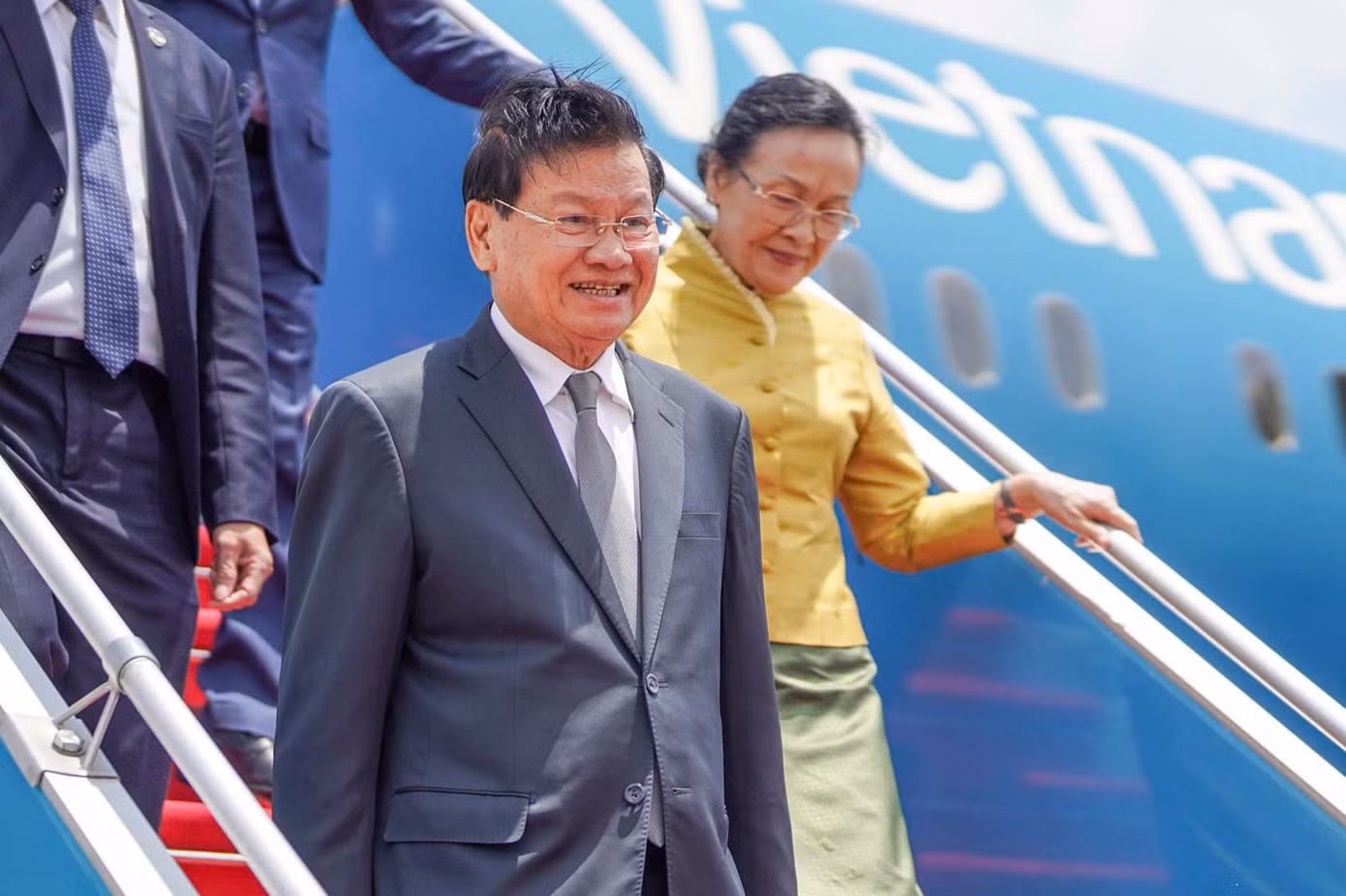 Tổng Bí thư, Chủ tịch nước Lào Thongloun Sisoulith và Phu nhân bước xuống từ máy bay, khởi đầu chuyến thăm TPHCM. Ảnh: Phạm Nguyễn