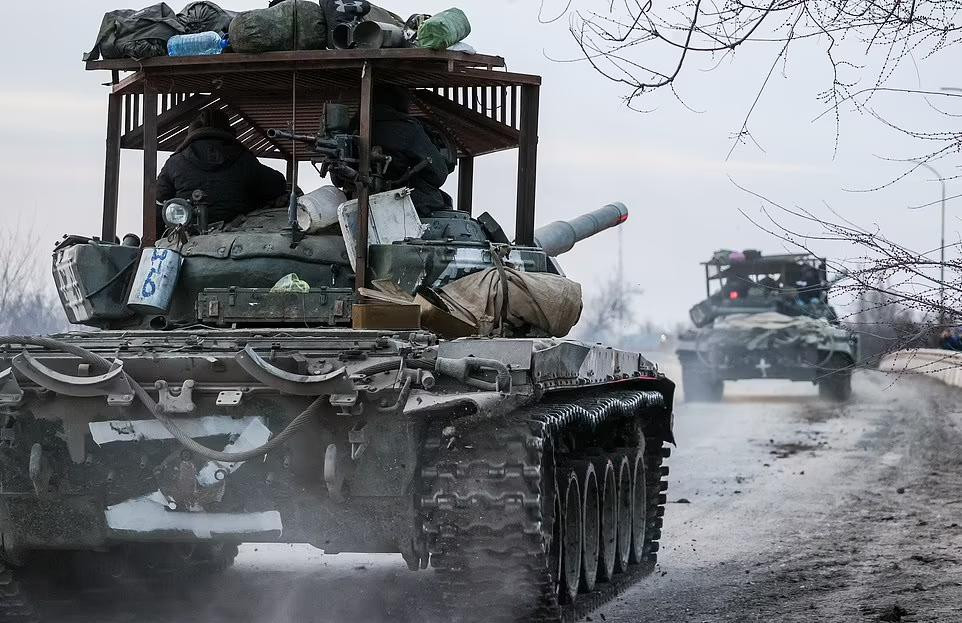 Xe tăng Nga (có giáp trên đầu để bảo vệ trước tên lửa xách tay Javelin của Mỹ) di chuyển qua thị trấn Armyansk, phía bắc Crimea, trên đường vào Ukraine. Ảnh: TASS.
