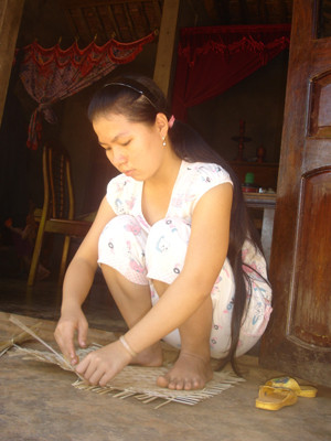 Nguyễn Thị Mỹ Liên đang đan mẹt giúp mẹ