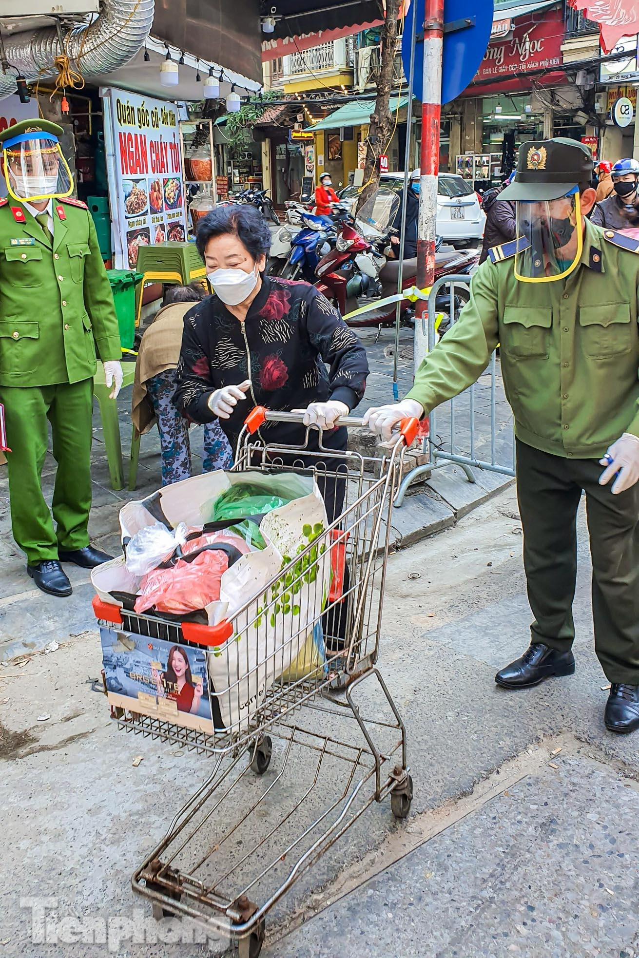 Lực lượng chức năng túc trực, giúp người dân vận chuyển lương thực, thực phẩm.