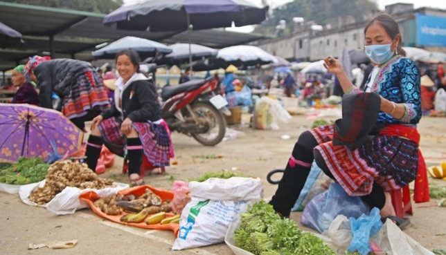 Khi chợ vắng khách, phụ nữ Mông tranh thủ thêu váy áo Ảnh: LỘC LIÊN Khi chợ vắng khách, phụ nữ Mông tranh thủ thêu váy áo Ảnh: LỘC LIÊN