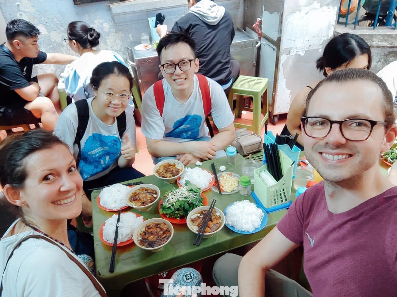 Hai du khách châu Âu cùng các bạn sinh viên thưởng thức món bún chả, trải nghiệm ẩm thực Hà thành. Hai du khách châu Âu cùng các bạn sinh viên thưởng thức món bún chả, trải nghiệm ẩm thực Hà thành.