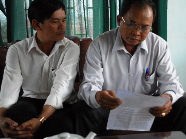  Ông Nguyễn Quang Sanh (phải) đang đọc đơn tố cáo
