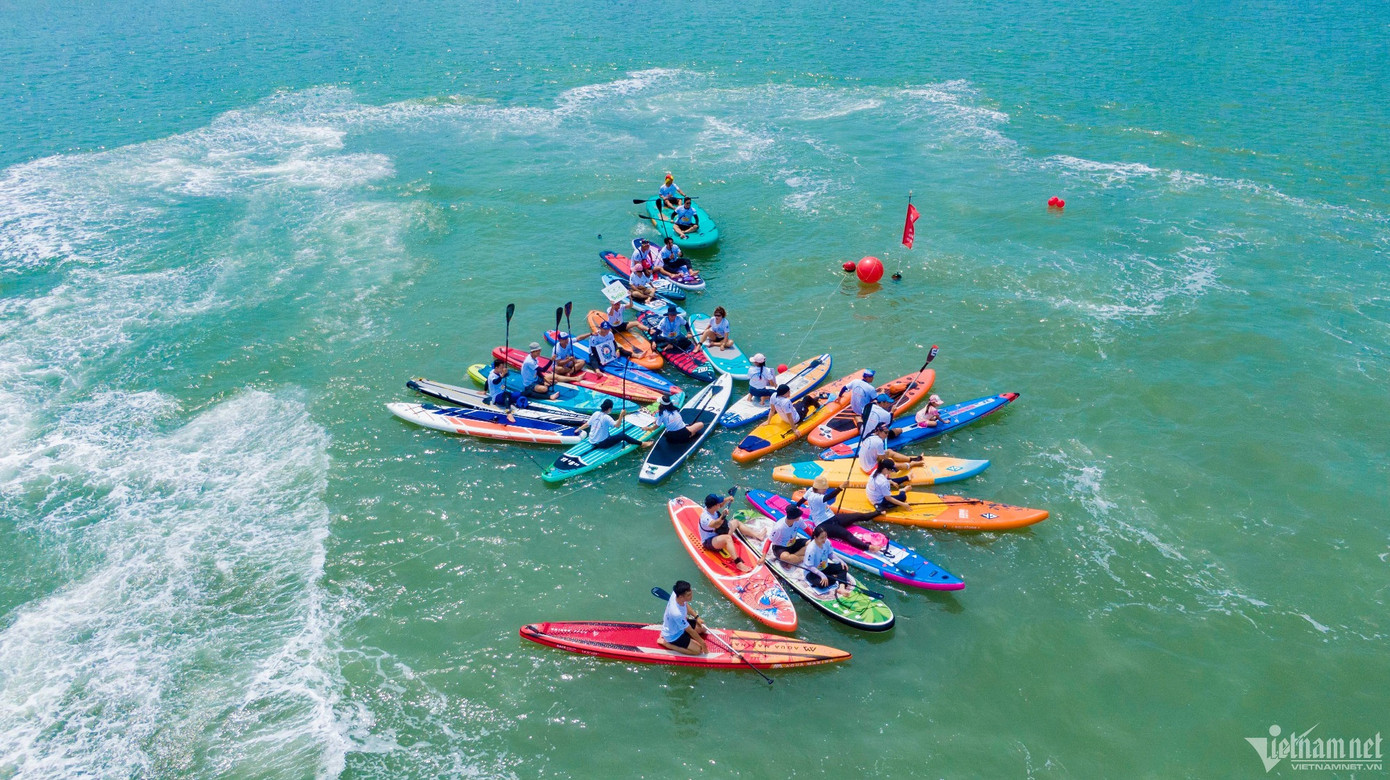 Ngoài tắm biển, ngắm diều, một số du khách chọn chèo SUP ở bãi Trước - Ảnh: Quang Thành