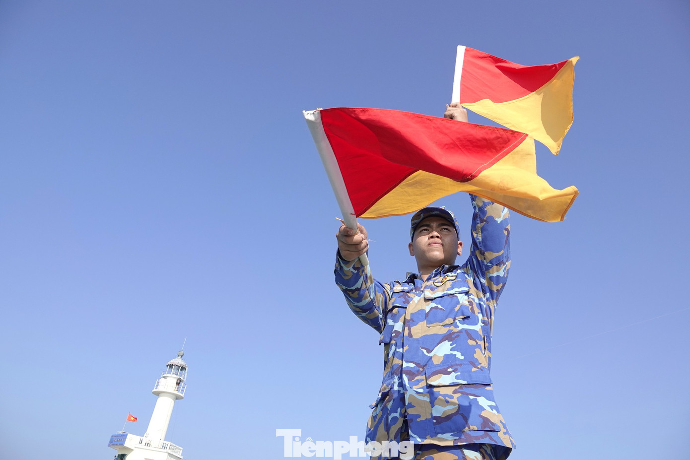 Chiến sĩ Hải quân dùng cờ tín hiệu hướng dẫn xuồng CQ đưa đại biểu vào thăm đảo Đá Tây B.