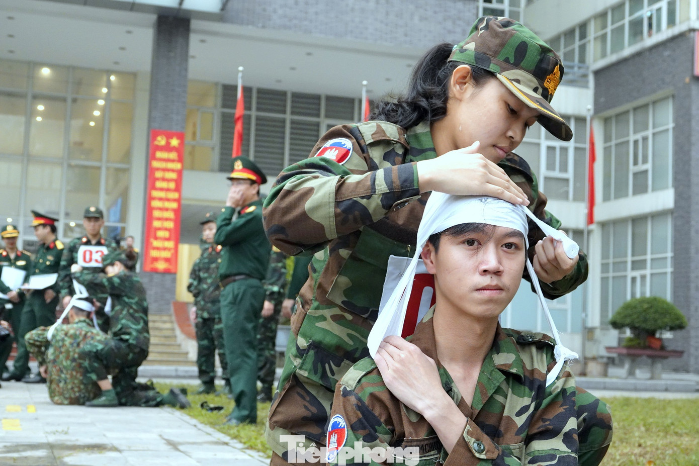 Thực hiện động tác băng bó cho thương binh (băng đầu múi bưởi) và cố định cẳng chân bằng nẹp cứng (gỗ hoặc tre).