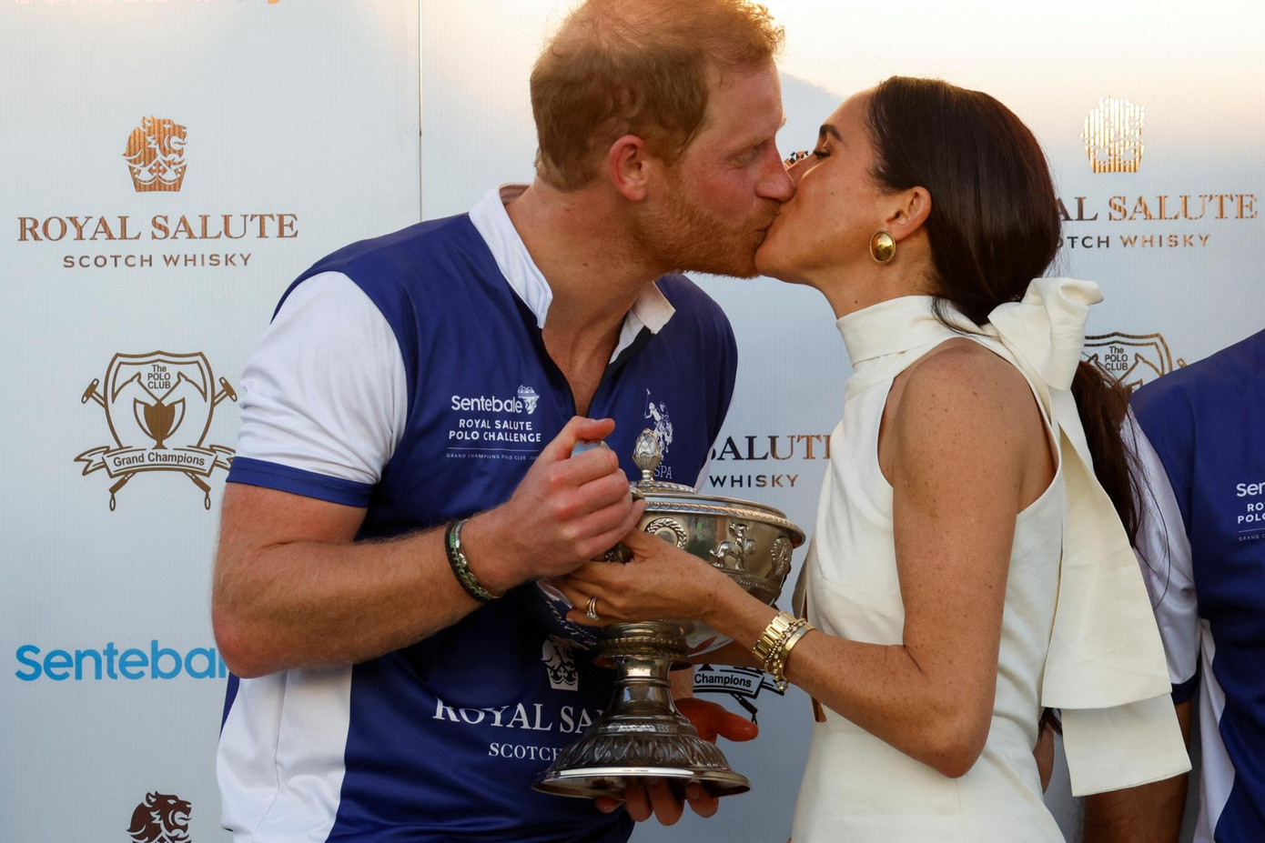 Meghan hôn chồng trong lần xuất hiện hiếm hoi trên phim. Ảnh: Reuters.