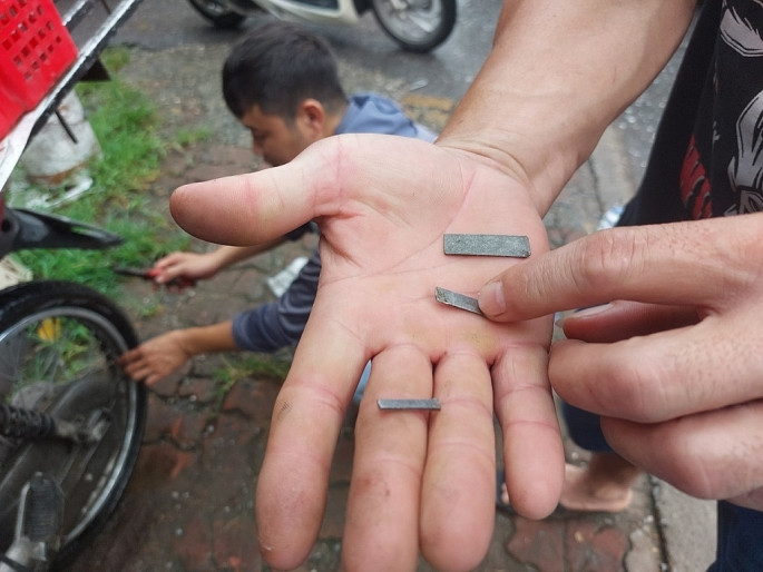 Thợ sửa xe máy lấy ra những mảnh tôn giống nhau (ảnh: C.P)