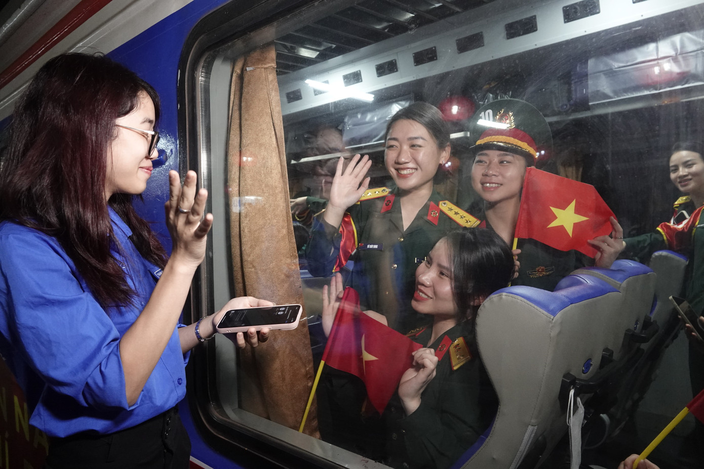 Các bóng hồng áo lính và hậu phương vẫy chào trước khi tàu chuyển bánh.