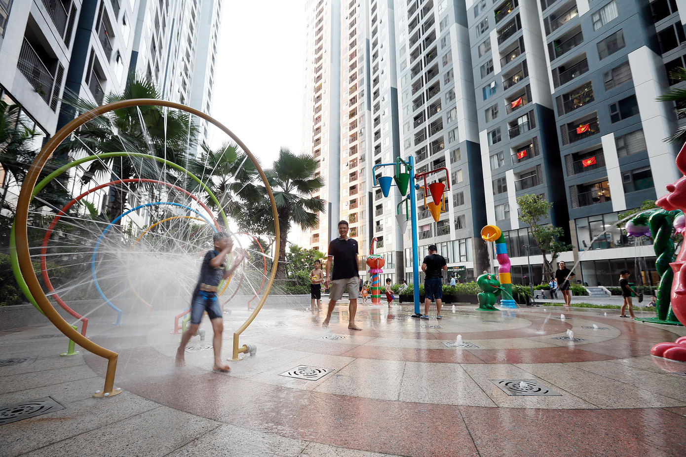 Bên cạnh khu vườn trên mái rực rỡ sắc màu, dưới chân tòa nhà, CĐT còn chú trọng đầu tư không gian vui chơi cho cư dân như: khu nhạc nước, khu vui chơi trẻ em, những con đường dạo bộ rợp bóng cây xanh. (Ảnh chụp trước ngày 1.5.2021) Bên cạnh khu vườn trên mái rực rỡ sắc màu, dưới chân tòa nhà, CĐT còn chú trọng đầu tư không gian vui chơi cho cư dân như: khu nhạc nước, khu vui chơi trẻ em, những con đường dạo bộ rợp bóng cây xanh. (Ảnh chụp trước ngày 1.5.2021)