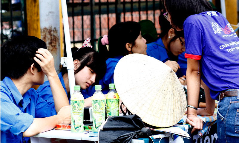 Trên bàn tư vấn có thêm ô, nón của các tình nguyện viên