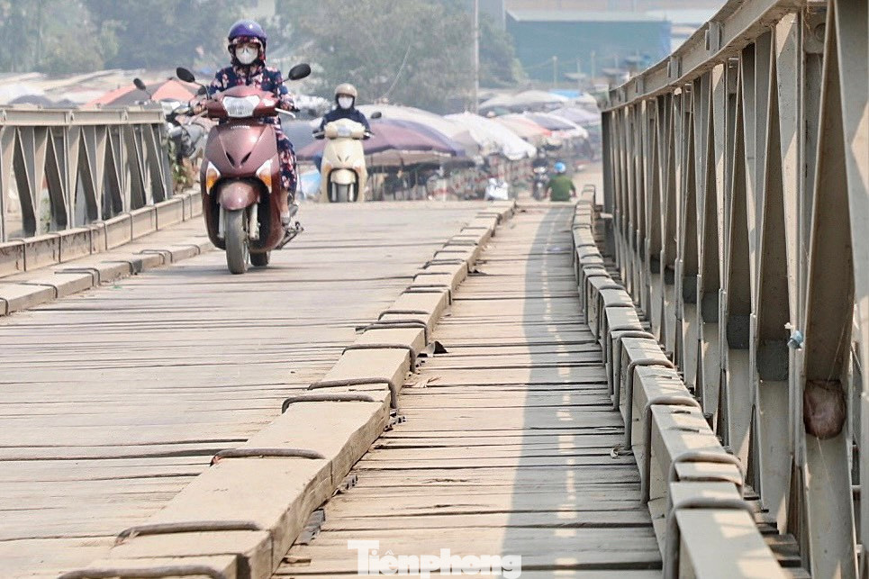 Sàn cầu lát bằng gỗ, dưới là những thanh dầm bằng sắt được liên kết với nhau rất chắc chắn, bảo đảm trọng tải xe qua cầu từ 15 đến 18 tấn. Sàn cầu lát bằng gỗ, dưới là những thanh dầm bằng sắt được liên kết với nhau rất chắc chắn, bảo đảm trọng tải xe qua cầu từ 15 đến 18 tấn.