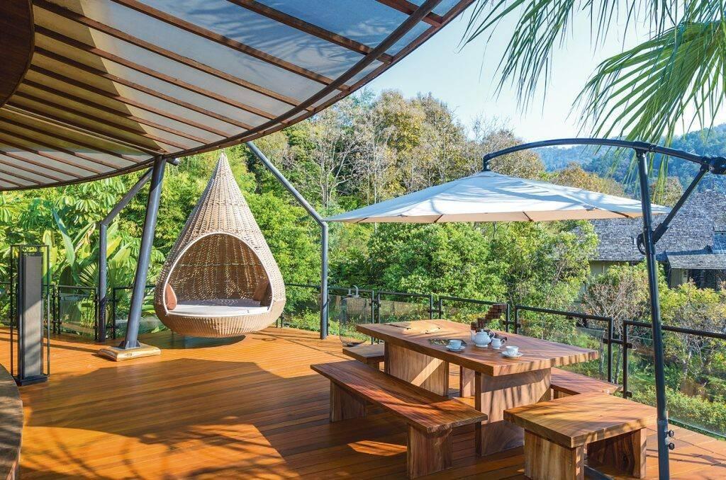 Ban công gỗ có tầm nhìn hướng ra khu vườn xanh mát, là địa điểm nghỉ ngơi, thư giãn lý tưởng của các thành viên trong gia đình sau một ngày dài làm việc.