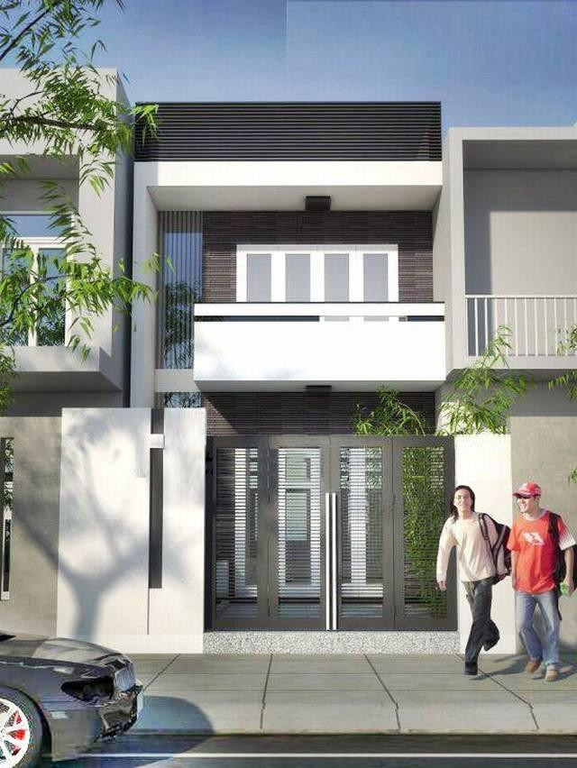 Mẫu nhà ống 2 tầng trong hình giúp thu hút mọi ánh nhìn nhờ sự phối hợp hài hòa giữa sắc đen và trắng pha thêm chút màu gỗ nâu ở mặt tiền. Cổng sử dụng hệ cửa 4 cánh rộng mở trong khi các mảng tường nhỏ ở mặt tiền tầng 1 và 2 được ốp đá giả gỗ tạo thêm điểm nhấn cho căn nhà.