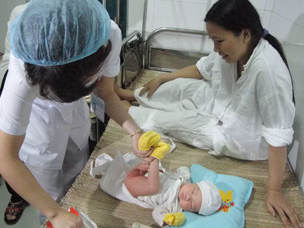 Nhân viên bệnh viện thay tã cho cháu Trường Ảnh: Trường Phong.