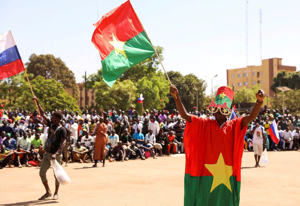 Một người dân Burkina Faso vẫy quốc kỳ ủng hộ chính quyền quân sự và ăn mừng việc đại sứ Pháp rời khỏi nước này. (Ảnh: Reuters)