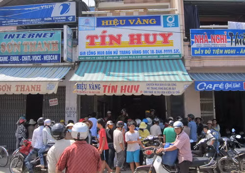 Người dân hiếu kỳ tụ tập trước tiệm vàng Tín Huy. Ảnh: Tuổi Trẻ