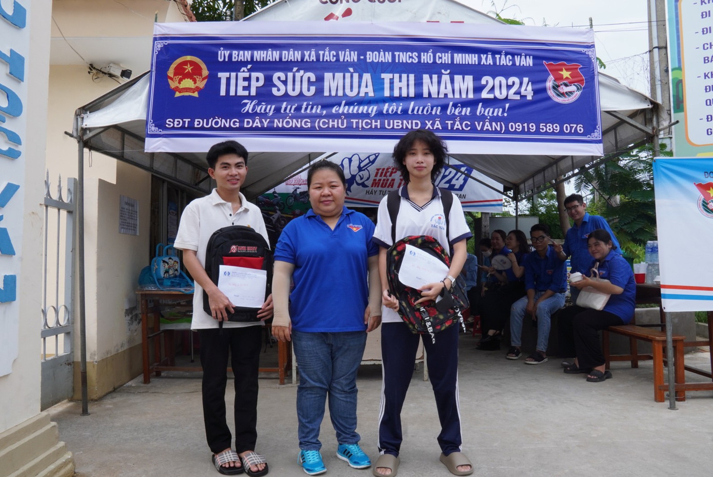 Chị Võ Tuyết Ngân trao học bổng "tiếp sức" cho Minh Thư (ngoài cùng bên phải) và Thái Hoàng (bên trái ảnh) chiều 26/6. Ảnh: Lam Khánh/tỉnh Cà Mau