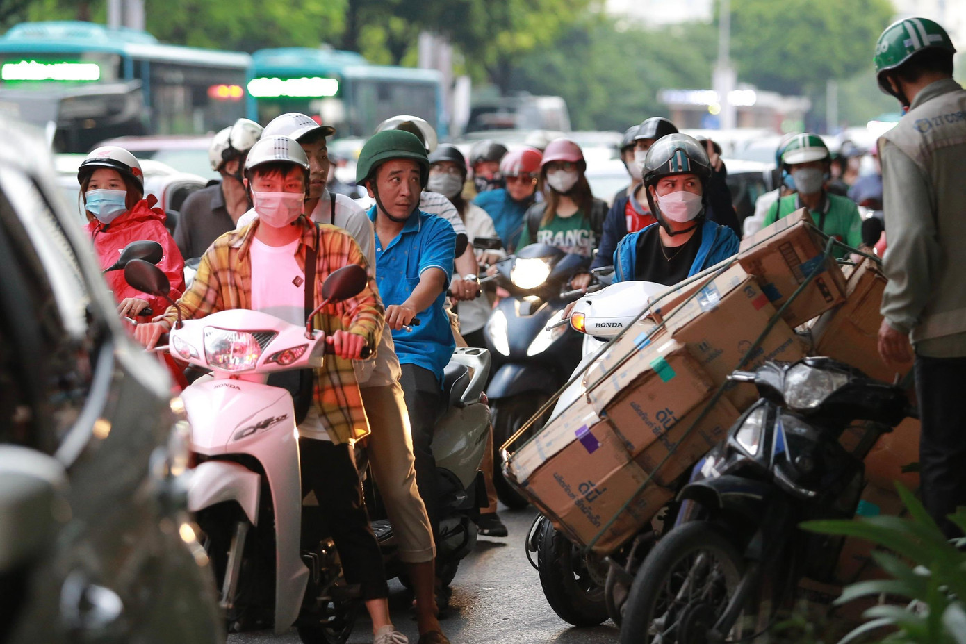 Người dân chật vật di chuyển trong tình trạng tắc đường và mưa.