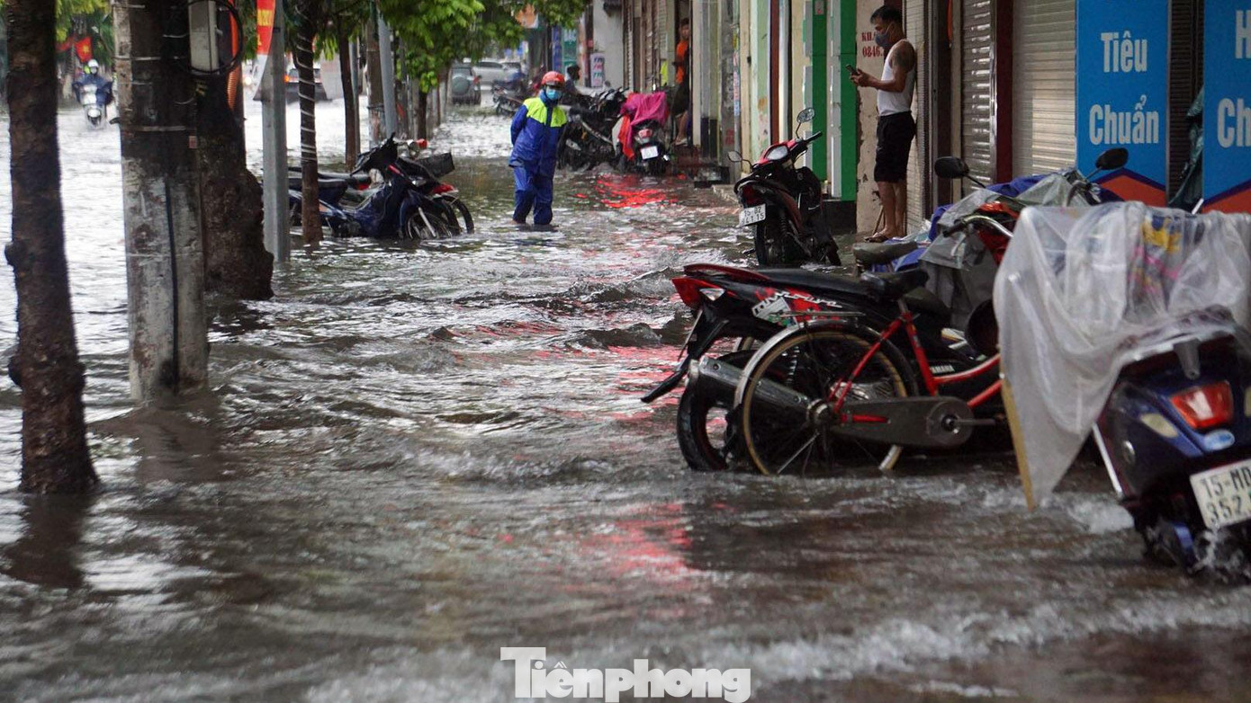 Đến trưa 5/9, TP Hải Phòng ngớt mưa tuy nhiên nhiều tuyến phố vẫn ngập sâu. Nhân viên thoát nước có mặt tại các điểm ngập sâu từ sớm thông đường cống thoát nước, dựng biển cảnh báo.