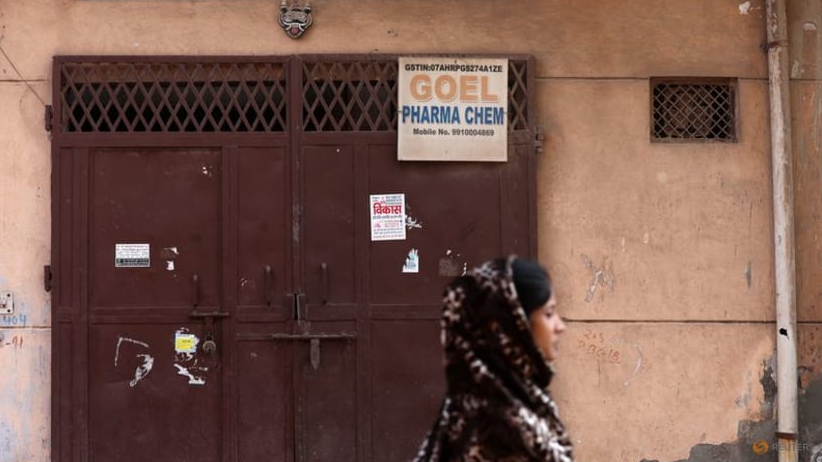 Một người phụ nữ đi ngang qua cánh cổng đóng kín của Goel Pharma Chem, công ty kinh doanh hóa chất đã cung cấp nguyên liệu cho hãng Maiden Pharmaceuticals sản xuất các loại xi-rô ho liên quan đến cái chết của nhiều trẻ em. (Ảnh: Reuters) Một người phụ nữ đi ngang qua cánh cổng đóng kín của Goel Pharma Chem, công ty kinh doanh hóa chất đã cung cấp nguyên liệu cho hãng Maiden Pharmaceuticals sản xuất các loại xi-rô ho liên quan đến cái chết của nhiều trẻ em. (Ảnh: Reuters)