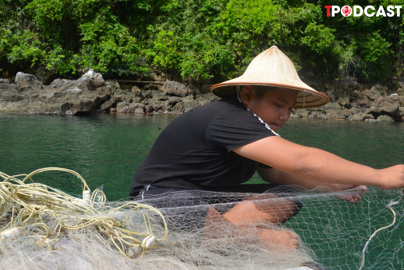 Lê Văn Đạt (11 tuổi) chuẩn bị lưới đánh cá phụ giúp bố mẹ trước khi ra khơi.