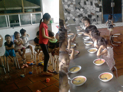 Những đứa trẻ mồi côi lớn cho các em nhỏ ăn .Ảnh: Gia Huy