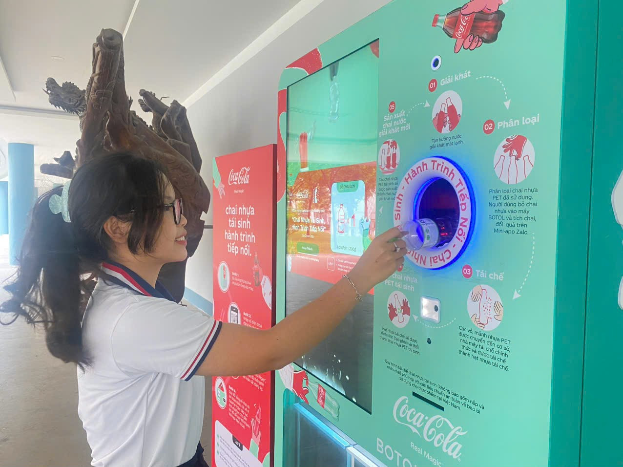 Sinh viên Trường Đại học Ngân hàng TP. HCM bỏ chai nhựa vào máy Botol.