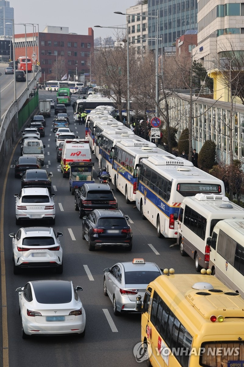 Hàng dài xe buýt gần dinh thự của ông Yoon. (Ảnh: Yonhap) Hàng dài xe buýt gần dinh thự của ông Yoon. (Ảnh: Yonhap)