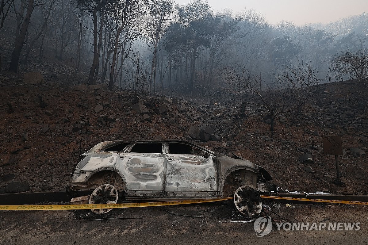 Một chiếc xe cháy trơ khung. (Ảnh: Yonhap) Một chiếc xe cháy trơ khung. (Ảnh: Yonhap)