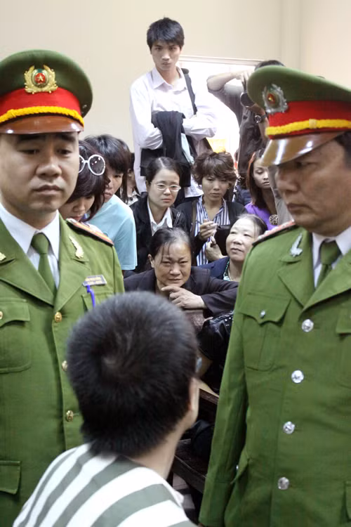 Trong lúc nghị án, Nghĩa cố gắng quay xuống động viên mẹ. Ảnh: Bảo Thắng Trong lúc nghị án, Nghĩa cố gắng quay xuống động viên mẹ