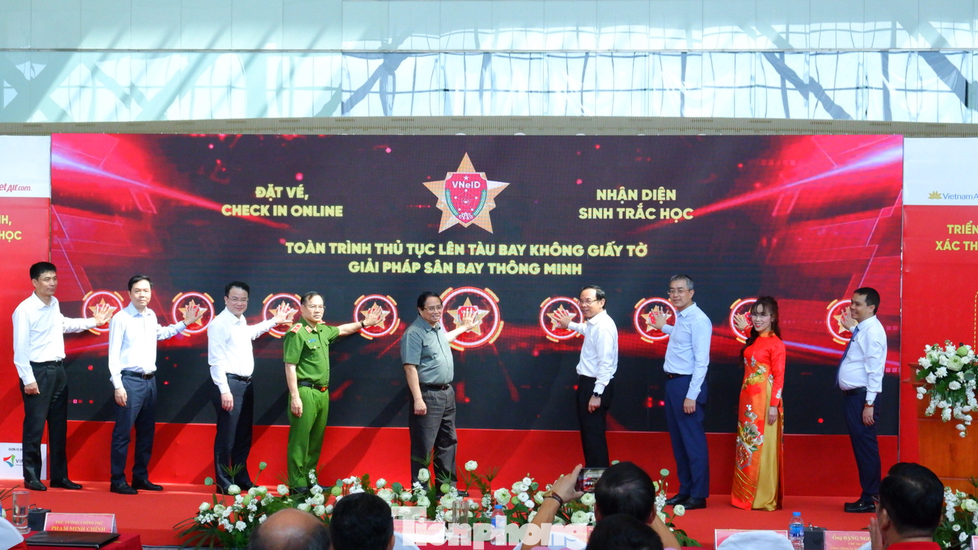 Thủ tướng Phạm Minh Chính và các đại biểu thực hiện nghi thức triển khai giải pháp ứng dụng định danh điện tử và nhận diện sinh trắc học phục vụ thủ tục lên tàu bay ở ga hành khách T3 Tân Sơn Nhất. Ảnh: Hữu Huy. Thủ tướng Phạm Minh Chính và các đại biểu thực hiện nghi thức triển khai giải pháp ứng dụng định danh điện tử và nhận diện sinh trắc học phục vụ thủ tục lên tàu bay ở ga hành khách T3 Tân Sơn Nhất. Ảnh: Hữu Huy.