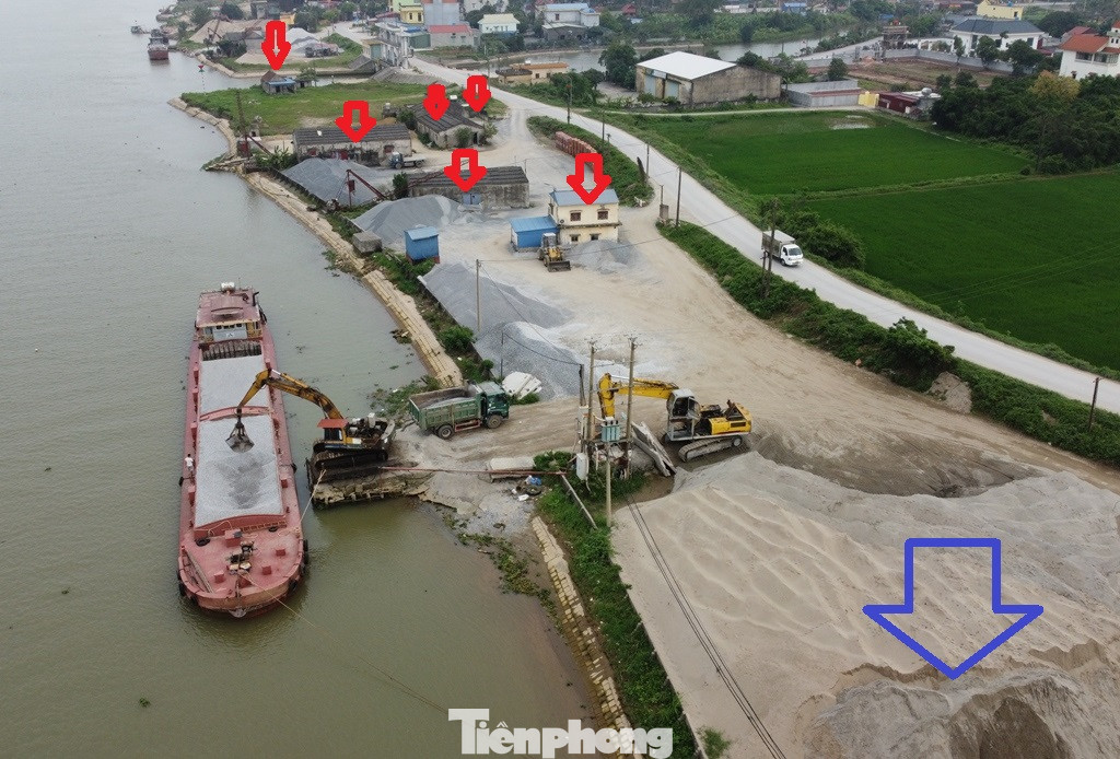 Cùng với bị lấn chiếm làm bãi chứa vật liệu, từ mặt đê, bờ đê, trong phạm vi bảo vệ an toàn đê đến hành lang chống lũ của sông Hồng đoạn qua xã Xuân Tân, huyện Xuân Trường cũng đang bị băm nát để làm cầu tàu, đường lên xuống cho xe tải, xây nhiều kho chứa, nhà điều hành (mũi tên đỏ)....