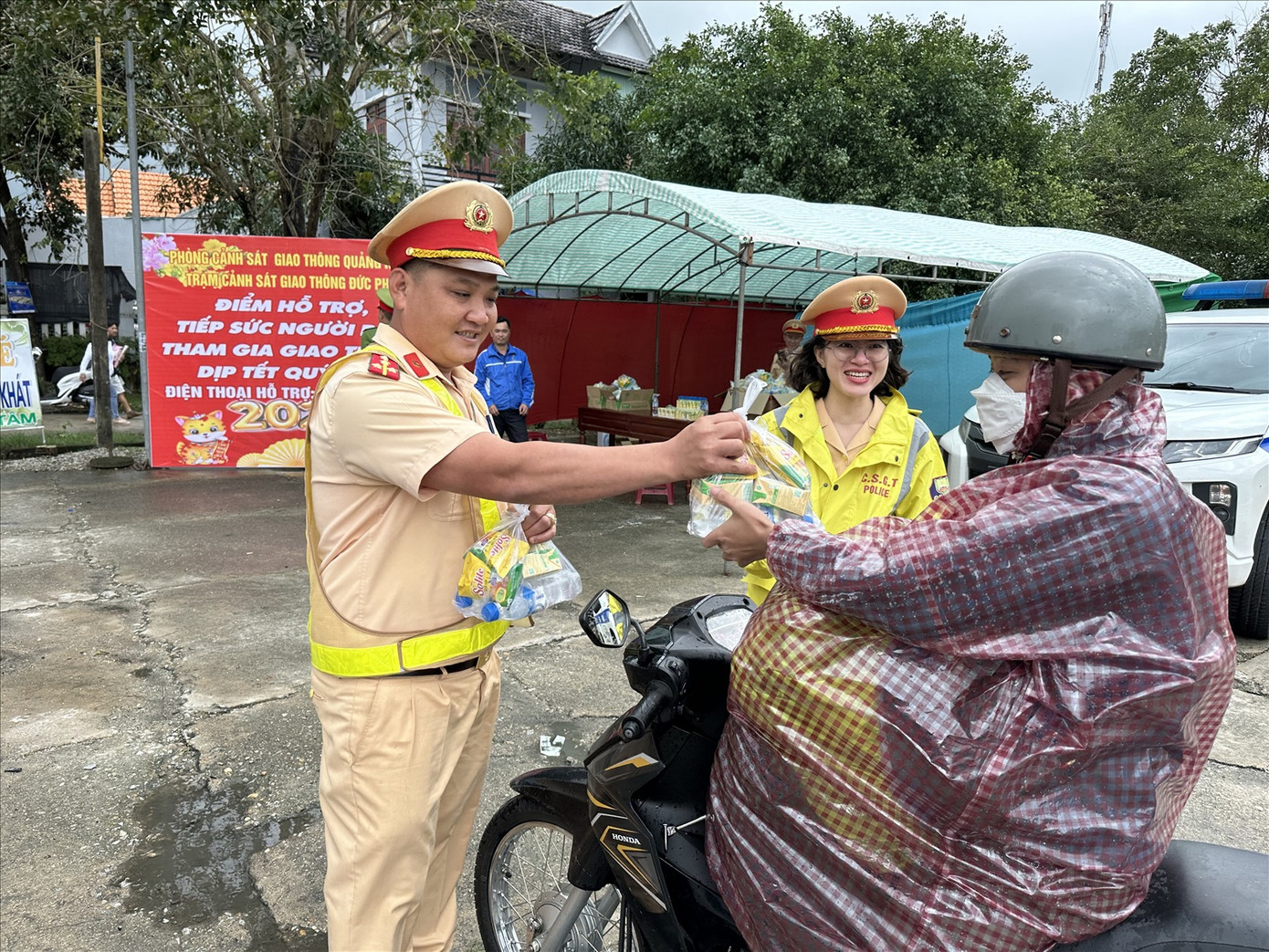 Cảnh sát giao thông Công an tỉnh Quảng Ngãi hỗ trợ người dân đi xe máy qua địa bàn.
