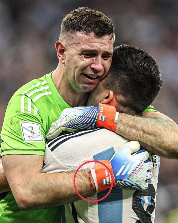 Thủ môn Martinez đeo sợi dây đỏ của Messi khi bắt luân lưu. Ảnh: Twitter.