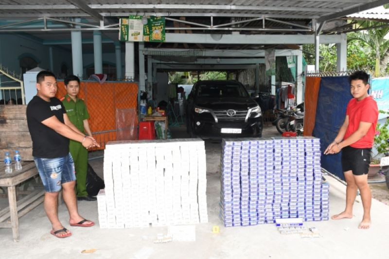 Hà Trọng Nghĩa (áo đen) và Văn Tiến Thanh (áo đỏ) cùng tang vật.