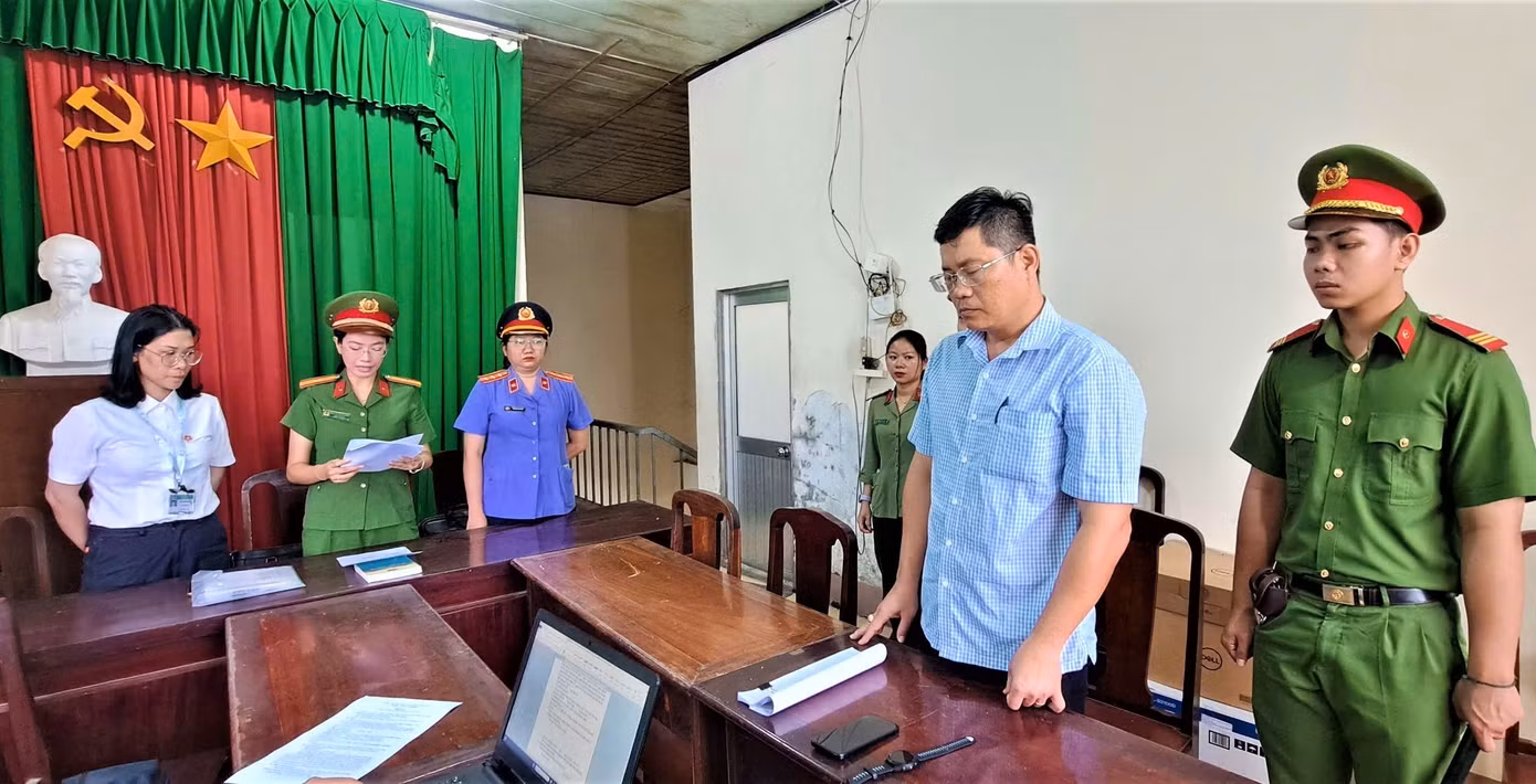 Công an tống đạt quyết định khởi tố bị can đối với Ngô Tấn Quốc (trái) và Phùng Ngọc Ngoan. Công an tống đạt quyết định khởi tố bị can đối với Ngô Tấn Quốc (trái) và Phùng Ngọc Ngoan.
