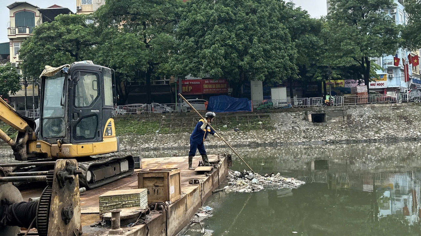 Đại diện Công ty TNHH MTV thoát nước Hà Nội cho biết, trước trong và sau mỗi cơn mưa lớn, đơn vị huy động 100% cán bộ công nhân ứng trực thoát nước ở các điểm úng ngập sau đó tiếp tục dọn dẹp rác tại các khu vực sông hồ. Đến chiều 3/7, rác trên mặt sông Tô Lịch, sông Lừ, sông Sét... cùng các sông hồ ở Hà Nội đã được dọn dẹp sạch sẽ. Trong ảnh: Công nhân thu gom rác thải chiều 3/7.