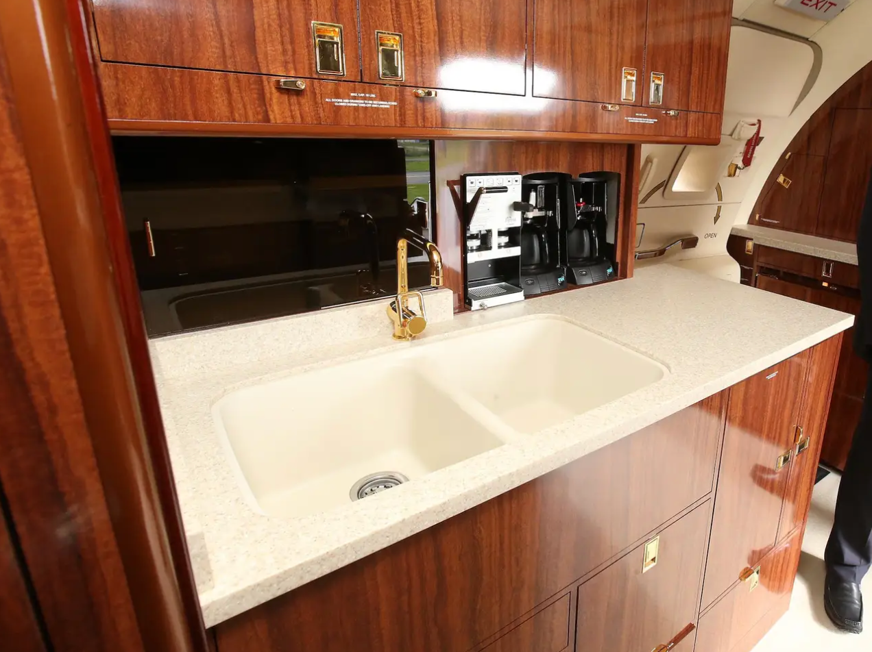 Bước vào phía đuôi chiếc máy bay là một căn bếp hoàn chỉnh với bồn rửa, máy pha cà phê và đồ dùng thủy tinh. (Ảnh: Getty).