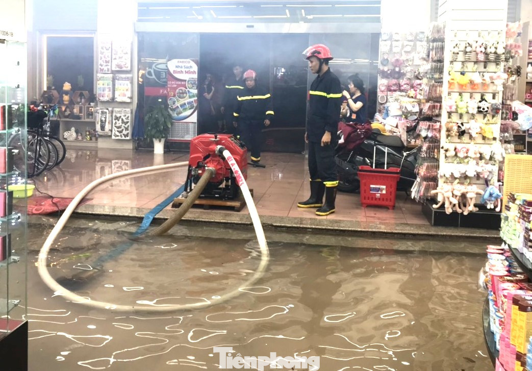 Nhà sách Bình Minh gần khu vực phong tỏa bị nước mưa tràn vào phải dùng máy bơm thoát nước