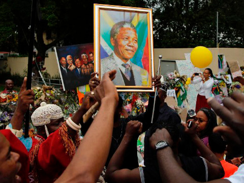 Người dân hát bên ngoài nhà cố tổng thống Nam Phi Nelson Mandela tại Johannesburg, hôm qua, mùng 9/12.