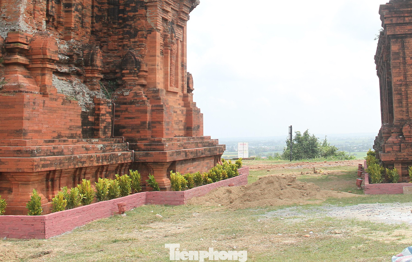 Xây gạch bồn hoa quanh chân Tháp Chính. Ảnh: T.Đ