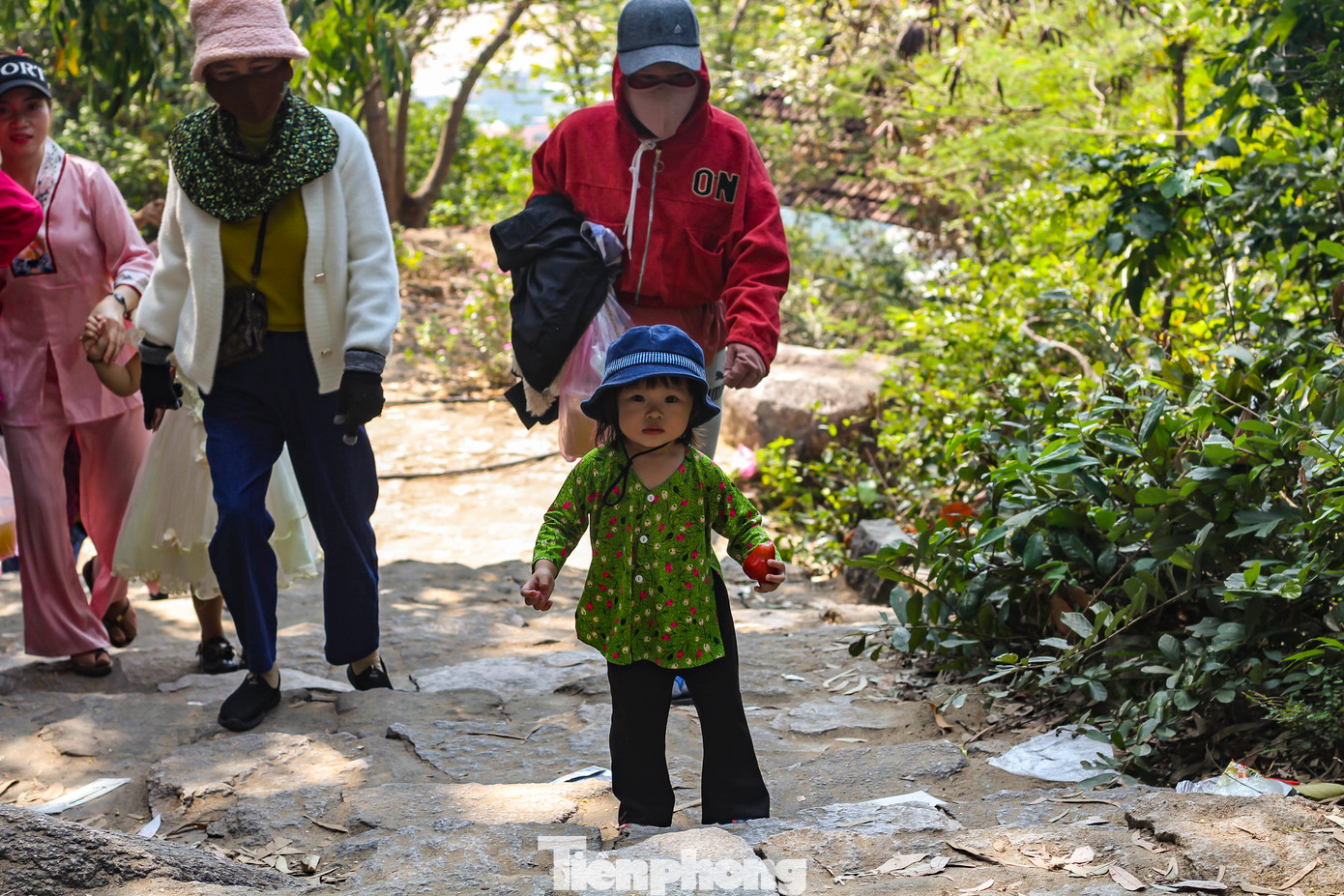 Một cháu bé cùng bố mẹ đi lễ chùa Ông Núi.